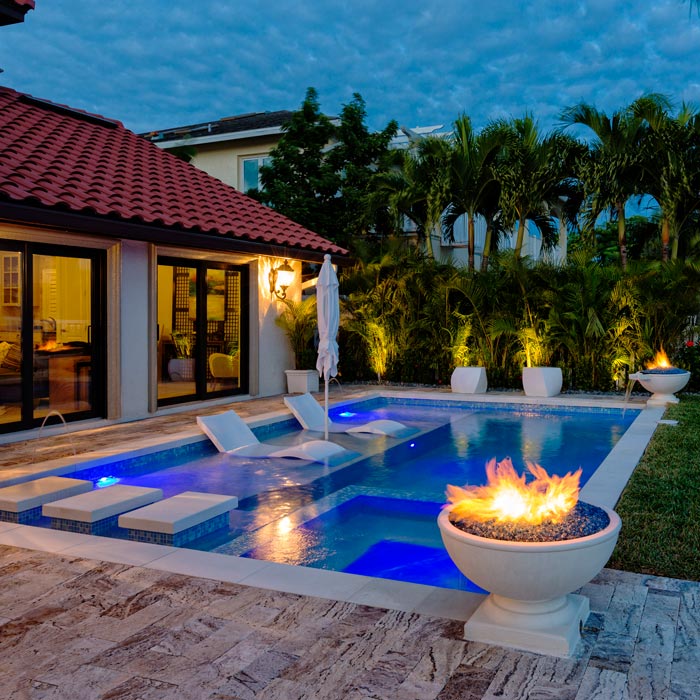 fire feature by pool at dusk in Naples, FL